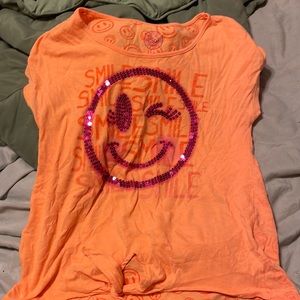 Light orange kids shirt with a smiley face on it